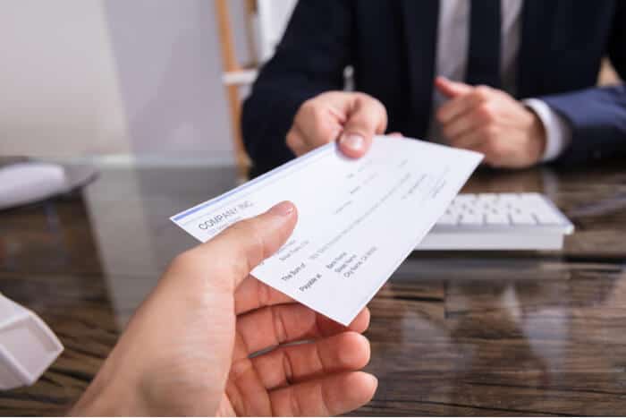 Banker handing over a check